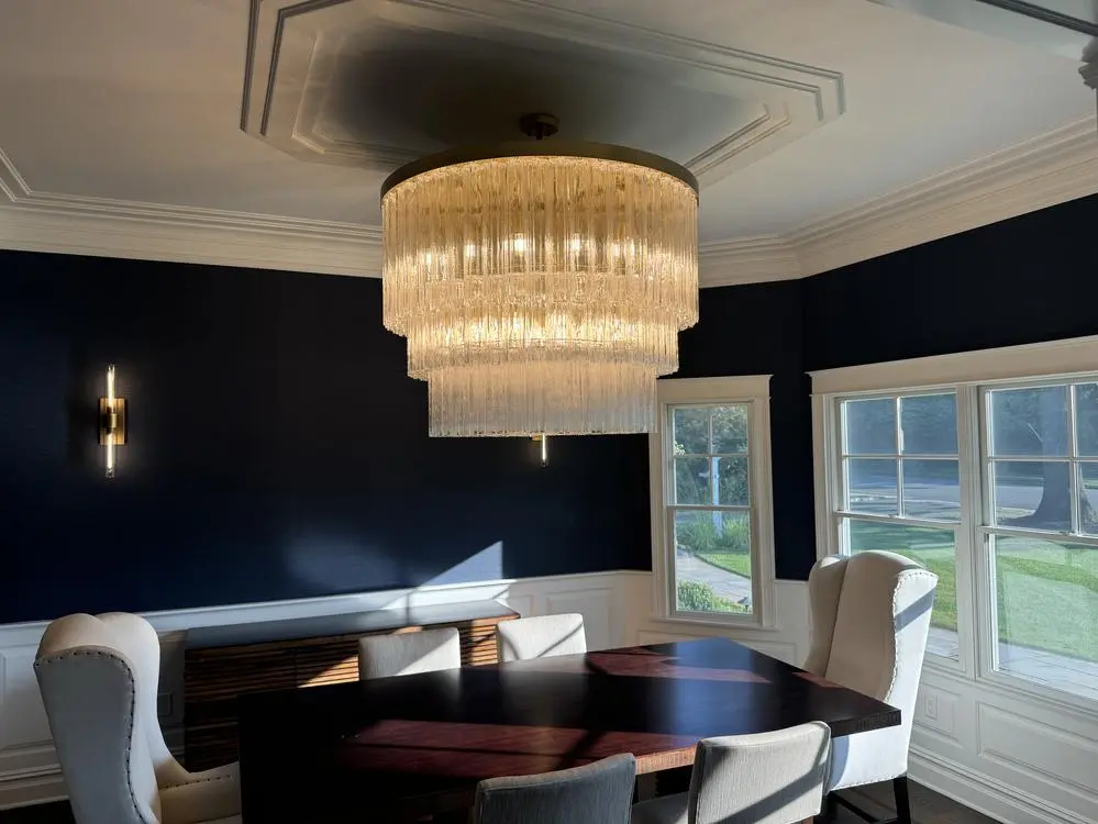 Multi-tier glass chandelier in a dining room
