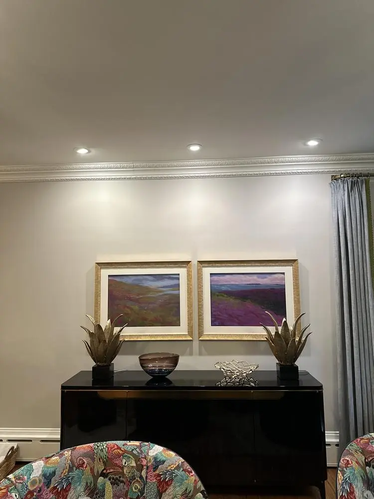 Recessed lights above a living room sideboard