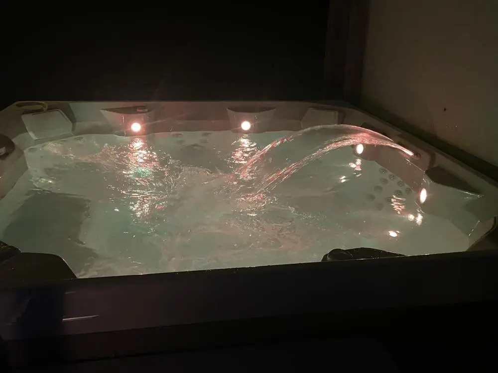 Outdoor hot tub lit at night